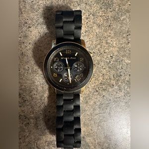 Michael Kors brand, regular wear.  Black and gold. For a small wrist.
